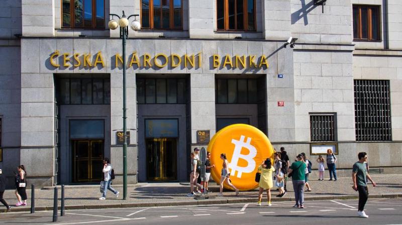 An image of a large inflated bitcoin coin in front of a bank in Prague, Czech Republic