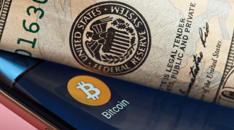 Bitcoin logo and Federal Reserve logo