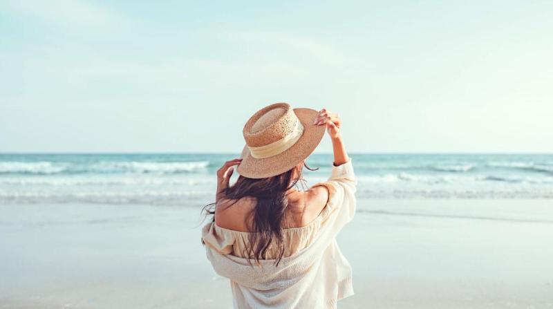 A woman enjoying her vacation at a beach in summer