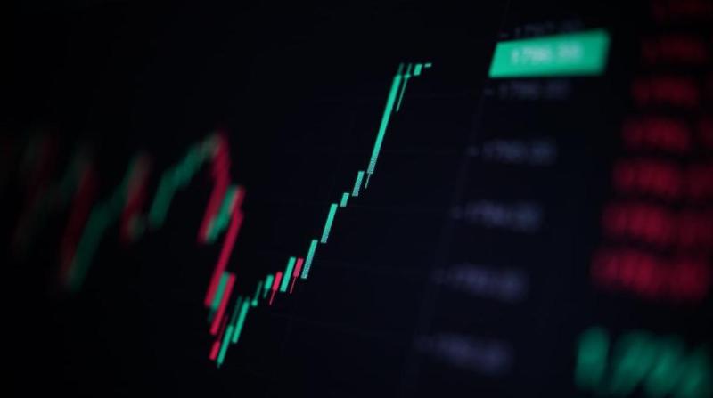 A green, rapidly rising candle chart of a crypto or stock price