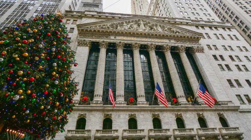 An image of a Christmas tree next to the New York Stock Exchange